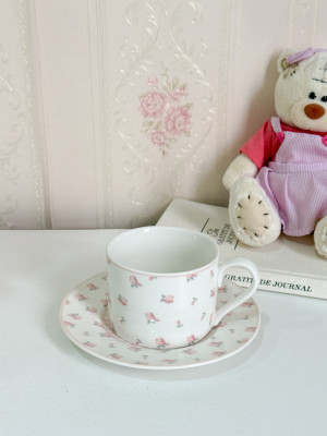 فنجان أبيض مع ورود زهرية ناعم