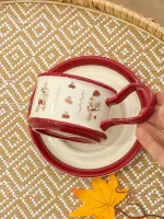 فنجان أبيض وأحمر مع رسمات كرز وفطر
